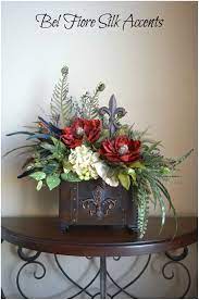 The dining chairs around the table have ornate carvings. Tuscan Decor Silk Flower Arrangement Dining Table In 2021 Flower Arrangements Silk Flower Arrangements Floral Decor