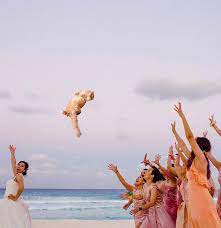 Traditionally, brides toss flowers to the other (usually single) women at a wedding reception. Brides Throwing Cats