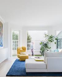 This wonderfully furnished white and yellow living room is centered around a lucite coffee table placed on a pastel striped rug. Best 60 Modern Living Room Floors Design Photos And Ideas Page 38 Dwell