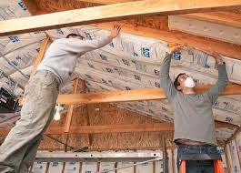 2 Men Putting Insulation In Ceiling Garage Remodel Garage Insulation Garage Floor Paint