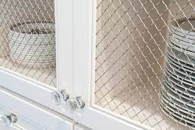 I really wanted something different than a window or typical decor, but something i could hang a wreath over to go on this wall over this cabinet. White Kitchen Cabinets With Chicken Wire Insert Traditional Kitchen Indianapolis By Case Design Remodeling Of Indianapolis Houzz