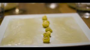 Copertina rigida e caratteri dorati impressi su una distesa bordeaux. Nashi Catering Massimo Bottura Tortellini Caminando A Facebook