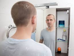 First, if you are beauty conscious, then not looking in the mirror will give you chance of. Young Handsome Man Looking At Mirror In Bathroom Stock Photo Picture And Royalty Free Image Image 41379447