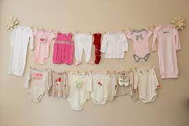 Onesie Clothesline Using Twine And Clothespins With Christmas Ribbon At The Ends Baby Shower Clothesline Baby Shower Onesie Baby Shower Banner Girl