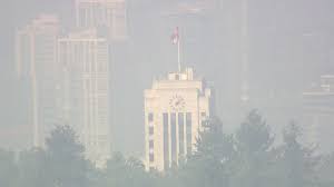 People walk at a park under the smoky sky in vancouver, british columbia, canada, aug. Smoke From B C Interior Wildfires Raises Air Quality Concerns For Metro Vancouver
