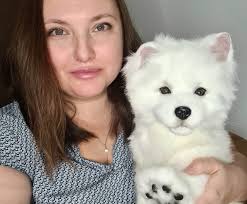 Samoyed. Realistic stuffed dog. Realistic movable toy.