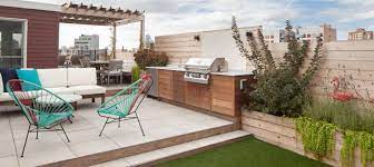 Turquoise chairs surround the rustic dining table. 12 Small Outdoor Kitchen Ideas