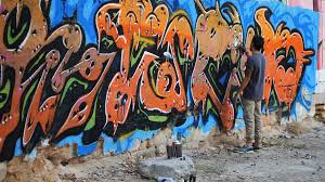 Graffiti Artist Painting On The Street Wall Handsome Man With Aerosol Spray Bottle Spraying With Colorful Paint Urban Outdoors Art Concept Slow Motion Back View Overall Plan Stock Video Footage Storyblocks