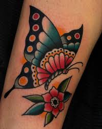 Yellow and black with a touch of violet butterfly arm tattoo. 40 Eye Catching Traditional Butterfly Tattoo Designs