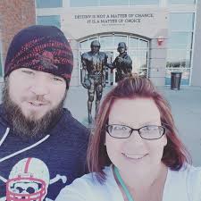 Here are 2 of my grandchildren Cody and his wife Maddie and me we each had  corner tables so we could talk so nice to be at the game every year