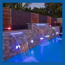 Empty wooden table with beautiful water fall for background. China Spa Waterfall With Led Light Waterfall For Swimming Pool Indoor Artificial Waterfalls China Waterfall And Sunblade Price