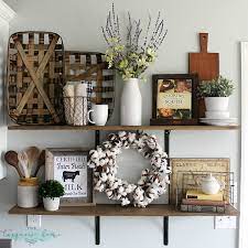 The wall shelves behind the sofa are a nice touch and can hold various decor pieces. Decorating Shelves In A Farmhouse Kitchen