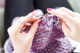 Rochester woman spreads july 4th cheer with caps for newborns that's what brings me joy: Woman Knitting Stockphoto
