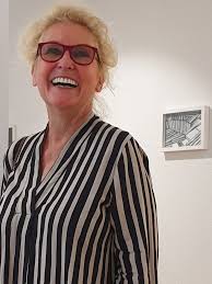 In front of art (27) by Celtic artists: Amanda Coogan from Ireland (work of  art in in red) and Steven Hautemanière from Brittany (painting in black and  white) at Basel gallery Kunstkomplex