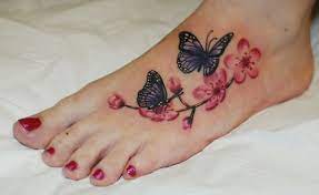Butterfly S And Cherry Blossoms Real Nice Realistic Colour Work From Ruslan Moshkin At Hammersmith Tattoo Sin Butterfly Foot Tattoo Foot Tattoos Foot Tattoo