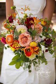 Maybe you would like to learn more about one of these? Stunning Bridal Bouquet With Peach Orange Yellow Red And Crimson Dahlias Roses Ranuncu Yellow Wedding Bouquet Yellow Bridal Bouquets Bridal Bouquet Fall