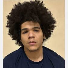 MURDER CHARGES. 17-year old Eugene Dale Thompson (left) is accused of  shooting and killing Larry Boyd, a Traverse City parking services worker, 