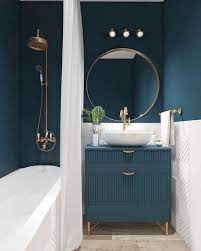 A chic contemporary bathroom with a blue printed tile accent wall, a neutral tub and walls, a wooden table and a potted plant. 30 Blue Bathroom Ideas 2020 Cool Stylish Bathroom Interior Design Bathroom Interior Bathroom Color Schemes
