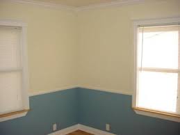 painting two colors with chair rail walls painted soft yellow and muted blue blue painted walls yellow walls dining room colors