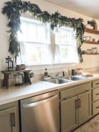 Tape the ribbon to the backside of your cabinet. Christmas Kitchen Window Garland The Little By Little Home