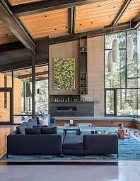 Spacious modern living room overlooking a forest. 21 Luminous Modern Living Rooms Showcasing Forest Views