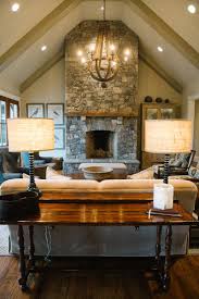 Gorgeous Living Room With A Vaulted Ceiling And Exposed Beams Stone Fireplace And Vaulted Ceiling Living Room Ceiling Lights Living Room Living Room Lighting