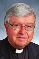 Bishop initiates three during Mass in Moberly prison