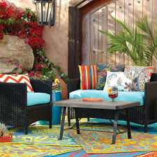 A rattan table that features a glass layer at the top. Cost Plus World Market Outdoor Furniture Sale Nar Media Kit