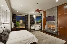 Natural looking hardwood floor with a master bed as a central piece. 17 Impressive Master Bedrooms With Fireplaces