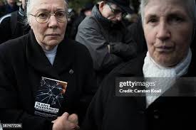 Michael Ickes, who lives nearby, lights candles at Stolpersteine... News  Photo