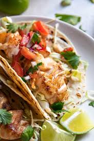 This recipe for cod fish tacos is seasoned white fish layered with corn cabbage slaw, a creamy sauce, avocado slices and a squeeze of fresh lime; Blackened Cod Fish Tacos With Fish Taco Sauce Modern Crumb