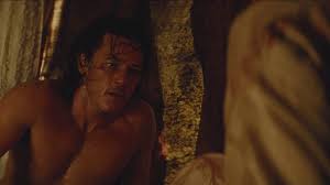 Handsome shirtless young musician playing guitar while jumping. Pin On Luke Evans