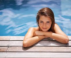 Contrary to popular belief, the typical swim cap doesn't really keep your hair from getting wet; How To Care For Your Skin Before And After A Swim