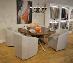 If you want contemporary glamor, coordinate metallic modern dining chairs with the chandelier for an overall chic effect. Edina Castered Barrel Back Arm Chair Designmaster Furniture