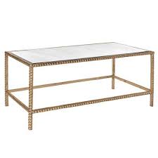 The studded coffee table is a part of the rock and roll theme. Studded Trim Gold Mirrored Coffee Table