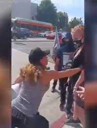 Horrific moment anti-masker punches breast cancer patient in her surgery  scars during protest outside hospital | The Sun