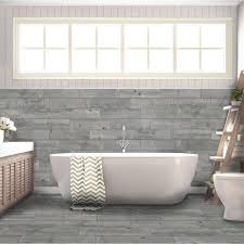 Gold and marble washstand with sunburst mirror facing a bathroom wall finished with gray marble tiles and upper white and gray wallpaper print. Florida Tile Home Collection Timber Grey 6 In X 24 In Porcelain Floor And Wall Tile 14 Sq Ft Case Chdedst106x24 The Home Depot