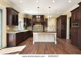Dark Wood Cabinets With White Island Luxury Vinyl Plank Flooring Home Luxury Kitchen Design