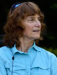 A team of 12 prepares to race down the Missouri River standing