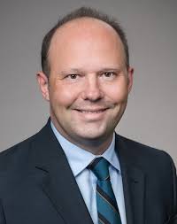 Aaron E. de Leest Promoted to Senior Counsel