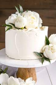 Small white wedding cake with flowers. This Lemon Elderflower Cake Is My Copycat Version Of The Royal Wedding Cake Elderflower Infused Lem Royal Wedding Cake Small Wedding Cakes Simple Wedding Cake