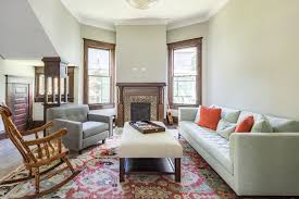 A large white formal living room boasting a skylight on the ceiling providing brightness to the space. 15 Formal Living Room Ideas You Would Love