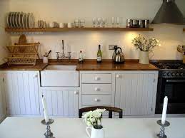 In this example, a small rustic island is set amid a modern farmhouse kitchen. Pin By Emily Danser On Kitchen Inspiration Faye Bridgwater Small Rustic Kitchens Rustic Kitchen Rustic Kitchen Decor