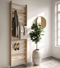 A coat rack is a simple wall hanging. Wall Mounted Coat Hanger Rack Locus Ladder Mater Design