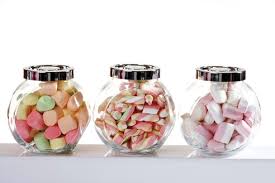 Candy, salt, cookie cool terrarium bottle. Marshmallows In Candy Jars Stockphoto
