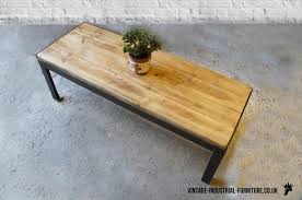 The tabletop is made from solid pine wood and has a butcher block style with visible. Vintage Industrial Rectangular Coffee Table