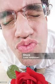 Guy Trying To Be Romantic Giving A Kiss Holding Rose Stock Photo