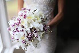 Add light and dark shades of purple daisies to your bouquet. White And Purple Orchid Bouquet