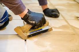 Removing grout with a grout removal tool. How To Grout Tile In 6 Simple Diy Steps Architectural Digest