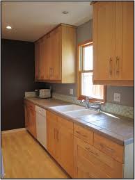 Maple Cabinets Gray Counters And Short Glass Backsplash Backsplash Designs Cheap Backsplash Tile Beadboard Backsplash